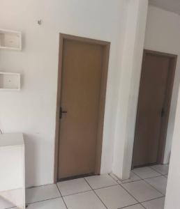 a hallway with two doors in a room at Quarto confortável COP30 in Belém