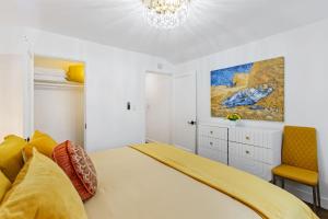 a bedroom with a large bed and a chandelier at Beautiful renovated house in Downtown Napa 4BD 2BA in Napa
