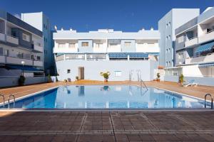 a swimming pool in the middle of a building at Puertito Azul in Puertito de Güímar