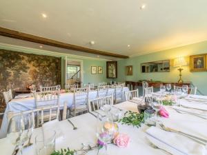 a set of tables in a room with white tables and chairs at 9 Bed in Ingoldisthorpe KT095 in Ingoldisthorpe