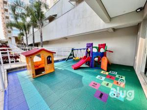a play area with a playground on a balcony at Pé na Areia Vista Mar Beto Carrero e Férias in Piçarras