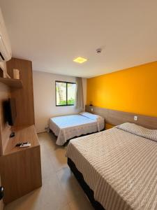 En eller flere senge i et værelse på Marulhos Resort Suites by CF2 + 37 billeder