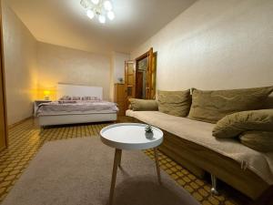 a living room with a couch and a table at Суворова-Титова in Dnipro