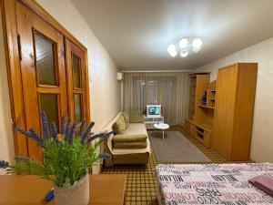 a living room with a bed and a couch at Суворова-Титова in Dnipro