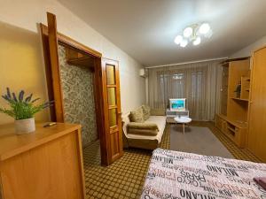 a hotel room with a bed and a chair at Суворова-Титова in Dnipro