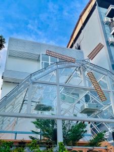 a glass facade of a building at Lazy Sunday Khaosan Hotel in Bangkok