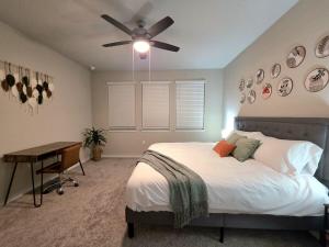 a bedroom with a bed and a ceiling fan at Austin House w Pool! by Airport, Tesla, and more! in Austin