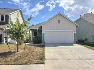 a house with a white garage and a tree at Austin House w Pool! by Airport, Tesla, and more! in Austin