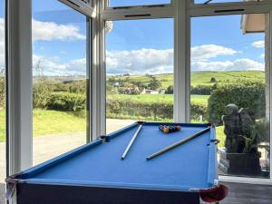 a pool table in front of a window at 5 Bed in Aberystwyth 95994 in Llanfihangel-geneuʼr-glyn