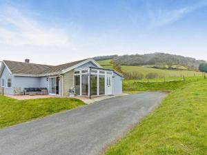 a house on a hill with a driveway at 5 Bed in Aberystwyth 95994 in Llanfihangel-geneuʼr-glyn