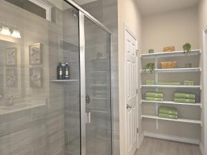 a bathroom with a shower and a glass shower stall at Austin House w Pool! by Airport, Tesla, and more! in Austin +25 photos
