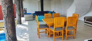 a wooden table and chairs in a living room at Blessed Rest Home Teques in Tequesquitengo