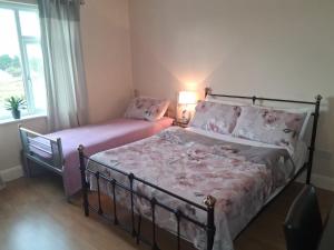 Postel nebo postele na pokoji v ubytování Sunset Room