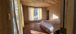 a bedroom with a bed and a window at ecolodge San miguel in Tupiza +3 photos