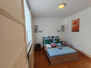 a small room with two beds and a window at Le Grand Coquet in Besançon