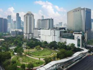 a view of a city with a train in the foreground at Novotel Bangkok Platinum Pratunam in Bangkok