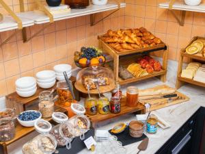 a buffet with various types of bread and pastries at Grand Hotel des Brotteaux Lyon Ctre - Handwritten Collection in Lyon