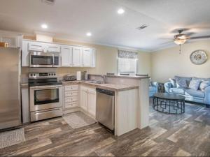 a kitchen with stainless steel appliances and a living room at Luxury Cabin#13 in Ocala