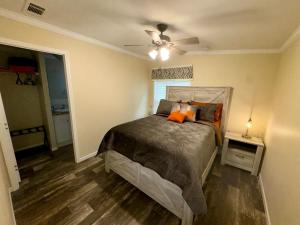 a bedroom with a bed and a ceiling fan at Luxury Cabin#13 in Ocala