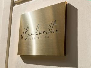 a metal box on a wall with the word laurimer vocabulary at Hotel Faubourg Galant Paris - Handwritten Collection in Paris