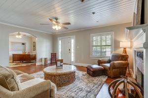 a living room with a couch and a table at Walk to Dtwn Hahira Inviting Home with Pool and Yard! in Hahira