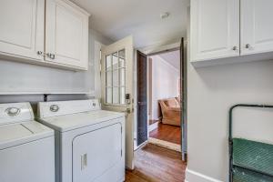 a kitchen with white cabinets and a washer and dryer at Walk to Dtwn Hahira Inviting Home with Pool and Yard! in Hahira +28 photos