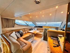 a living room of a boat with a couch and a table at Exclusive 2 in Çeşme