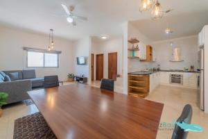 a living room with a table and a kitchen at Brand New Townhome with Private Rooftop in La Paz