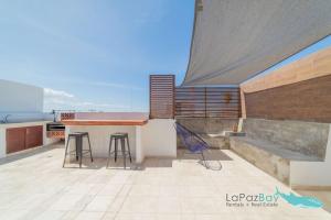 a kitchen with a counter and stools on a roof at Brand New Townhome with Private Rooftop in La Paz