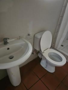 a bathroom with a white toilet and a sink at Jakaranda house in Pretoria +15 photos