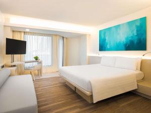 Postel nebo postele na pokoji v ubytování Pullman Pattaya Hotel G