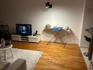 a living room with a television and a tripod at Basca Lux apartman in Sarajevo