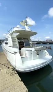a white boat parked at a dock in the water at Richesther cruise world in Lagos