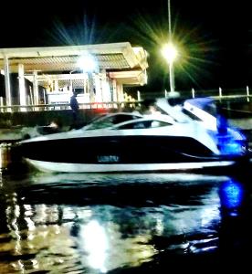a boat parked in a parking lot at night at Richesther cruise world in Lagos
