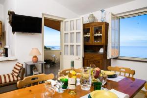 a dining room with a table with wine glasses at Attico Bouganville in Porto Alabe
