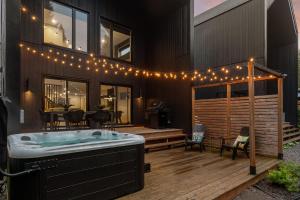 a house with a hot tub on a deck with lights at Le Mulligan in Pont-Rouge