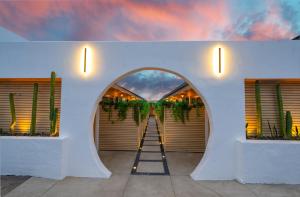 a ladder in front of a white wall with plants at The Boardwalk Hotel in San Diego +38 photos
