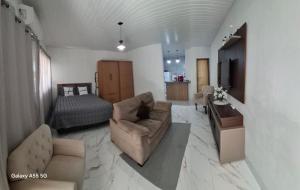 a living room with a couch and a bed at Apt estiloso in Sinop