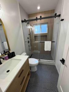 a bathroom with a shower and a toilet and a sink at New Luxury 1BR ADU Near Downtown & Tech Hubs in San Jose +12 photos