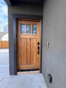a wooden door on the side of a house at New Luxury 1BR ADU Near Downtown & Tech Hubs in San Jose