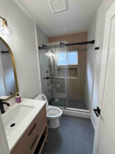 a bathroom with a shower and a toilet and a sink at New Luxury 1BR ADU Near Downtown & Tech Hubs in San Jose