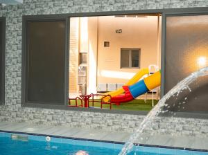 a pool with a slide and a water slide at استراحة روضة الوادي - Rawdat Al Wadi House in Nizwa +12 photos