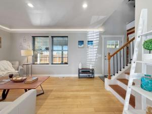 a living room with white walls and a wooden floor at Alderwood Escape in Sequim