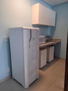 a refrigerator in a kitchen with a counter at Quinta da Praia in Serra