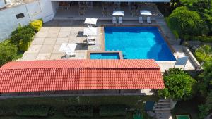 an overhead view of a swimming pool with a red roof at Hotel San Felipe in Oaxaca City