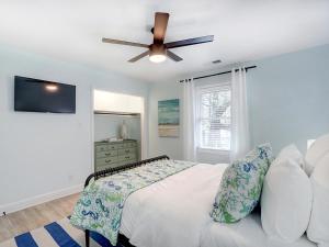 a bedroom with a bed and a ceiling fan at Deja Blue B in Tybee Island +22 photos