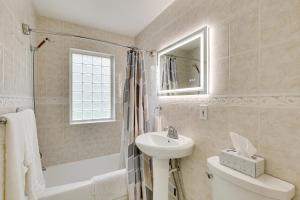 a bathroom with a sink and a toilet and a bath tub at Topeka Farmhouse Hideaway 5 Mi to Downtown! in Topeka +21 photos