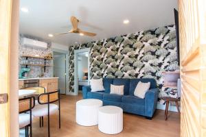 a living room with a blue couch and a kitchen at The Boardwalk Hotel in San Diego