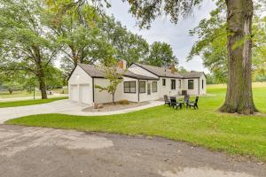 a white house with a picnic table and a tree at Topeka Farmhouse Hideaway 5 Mi to Downtown! in Topeka