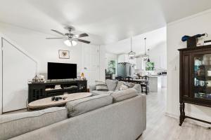 a living room with a couch and a flat screen tv at Nola Swamp Farm in Terrytown